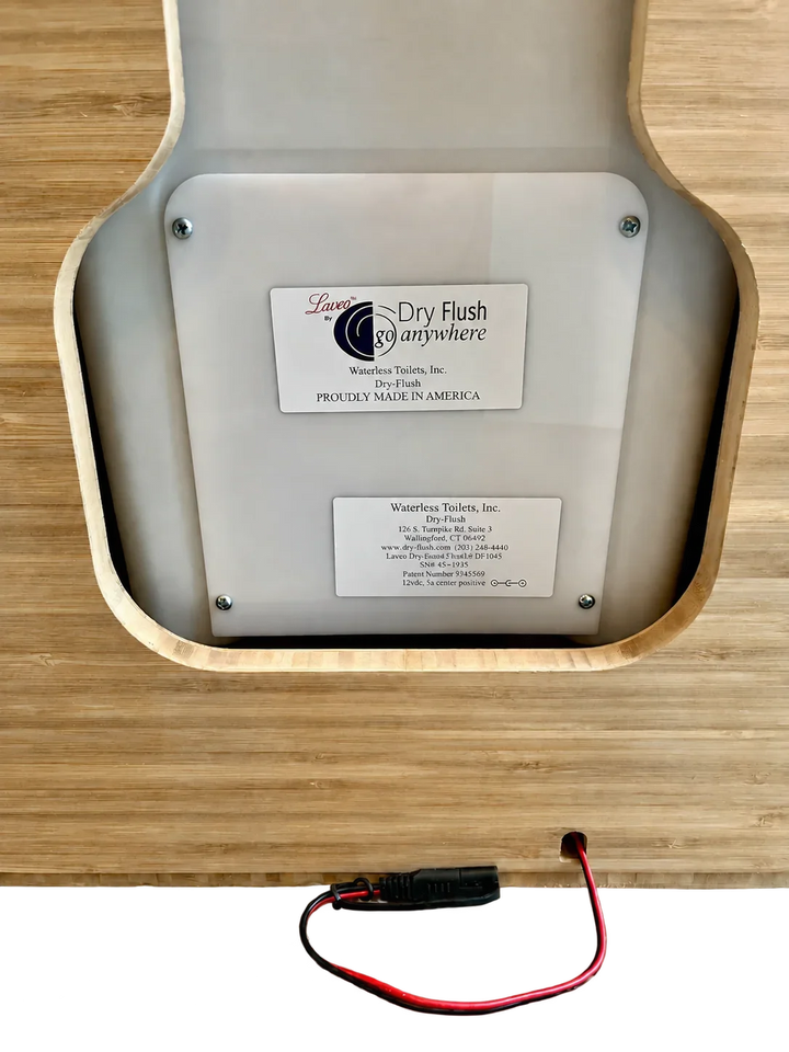 White Laveo Dry Flush toilet panel mounted inside a bamboo Weekender Outdoors cabinet.