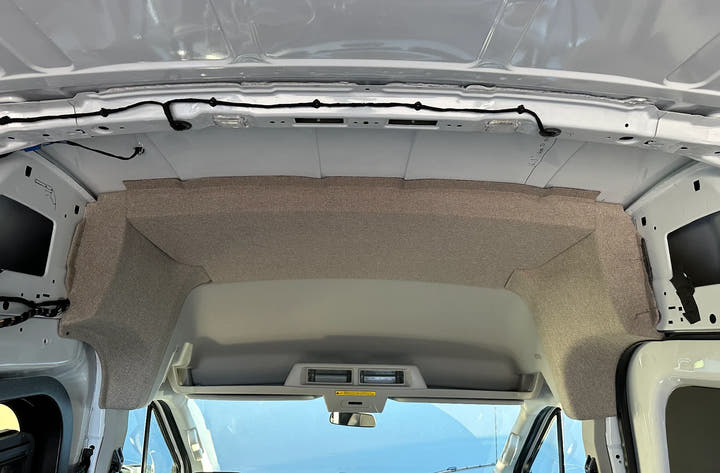Grey GoCode fabric headliner panel installed in a Ford Transit high roof camper van.